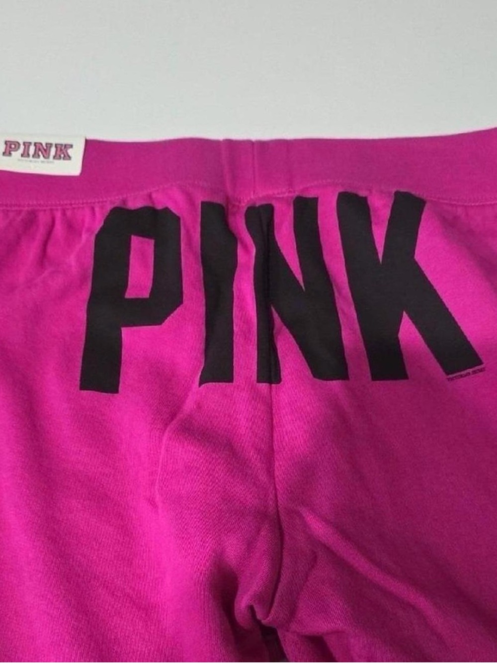 PINK Victoria's Secret Bright Pink cropped sweatpants with Black Print
